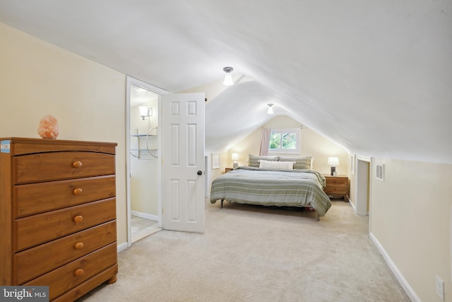 carpeted bedroom with lofted ceiling