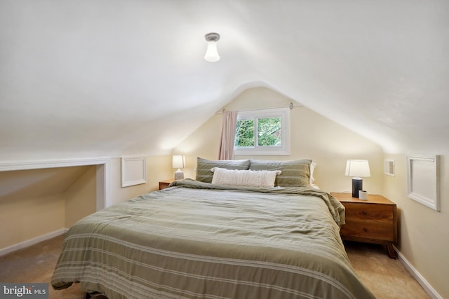 bedroom with carpet flooring and lofted ceiling