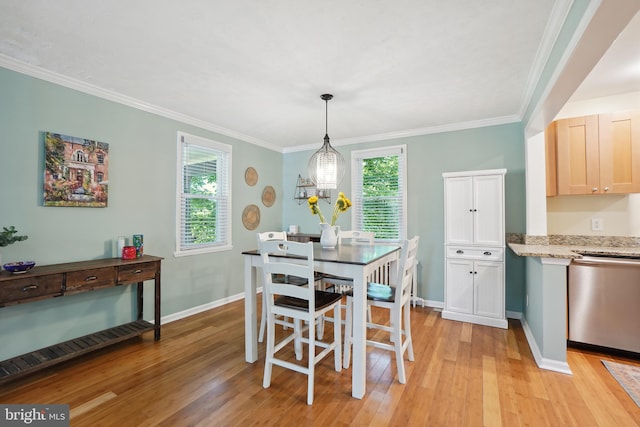 dining room with light wood-type flooring and ornamental molding