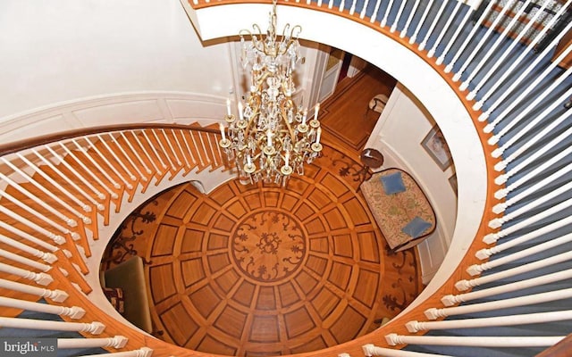 stairs featuring a notable chandelier