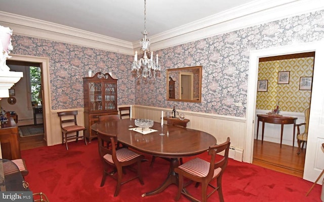 dining room with crown molding, hardwood / wood-style flooring, and a chandelier