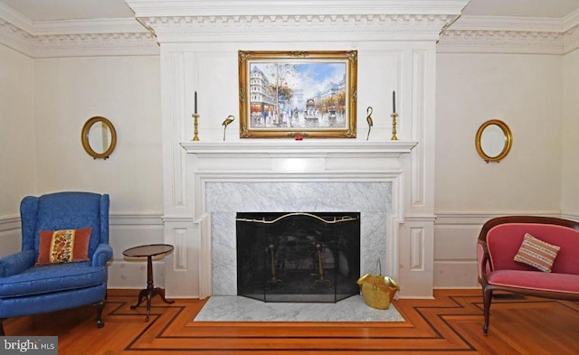 living area featuring a premium fireplace and crown molding