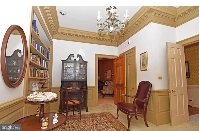 sitting room with an inviting chandelier, a towering ceiling, a baseboard radiator, ornamental molding, and carpet floors