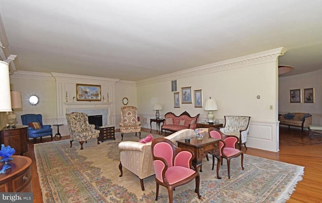 living room featuring a premium fireplace and hardwood / wood-style flooring