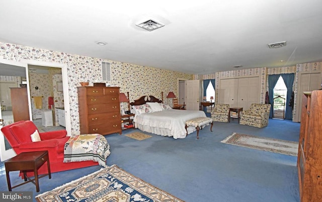 bedroom featuring ensuite bathroom and carpet