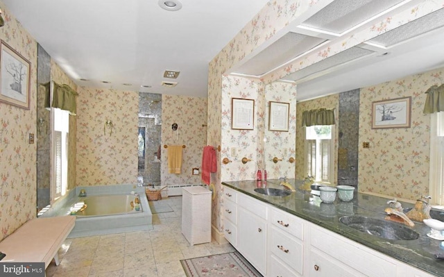 bathroom with tile floors, dual bowl vanity, a bathing tub, and baseboard heating