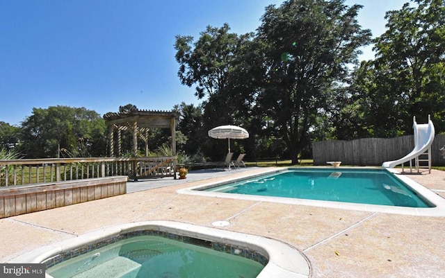 view of swimming pool featuring a water slide, a diving board, and a pergola