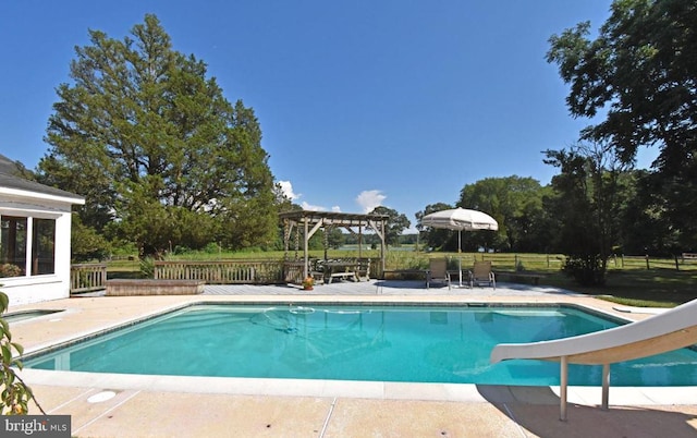 view of pool featuring a patio area, a pergola, and a water slide