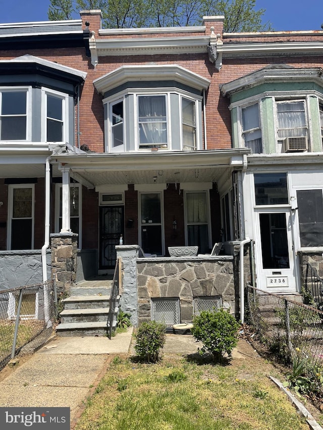 townhome / multi-family property featuring covered porch