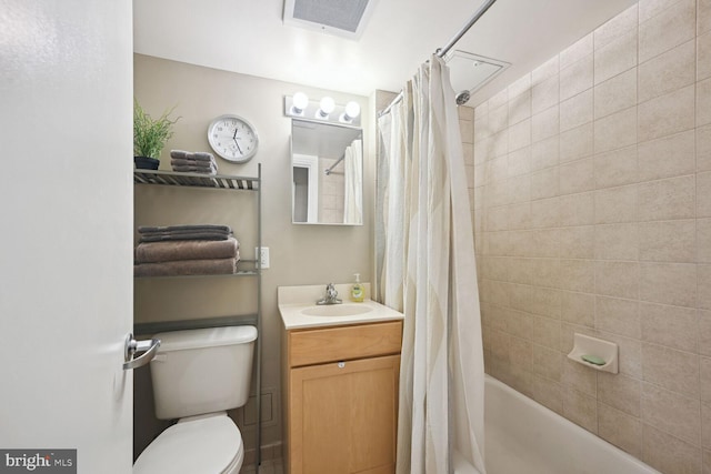 full bathroom with shower / tub combo with curtain, vanity, and toilet