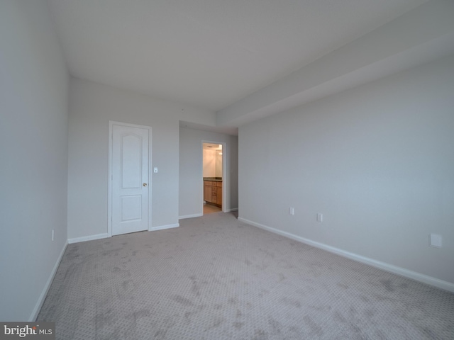 unfurnished bedroom with light colored carpet