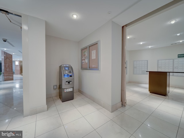 hall with mail boxes and light tile patterned floors