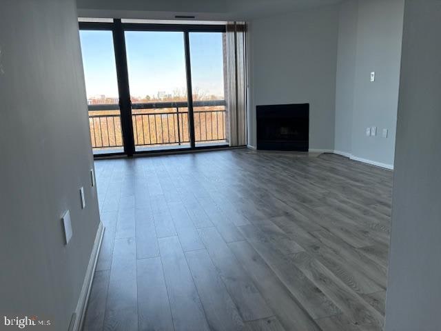 unfurnished living room with hardwood / wood-style floors