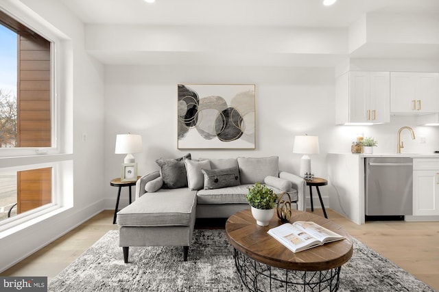 living room featuring sink and light wood-type flooring