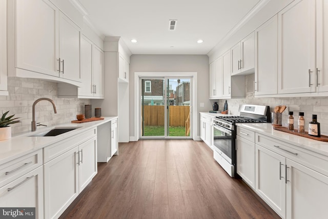 kitchen featuring white cabinetry, sink, dark wood-type flooring, and range with gas stovetop