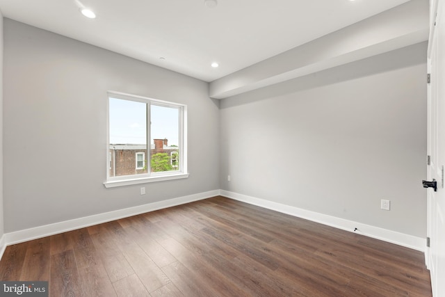 spare room with dark hardwood / wood-style flooring