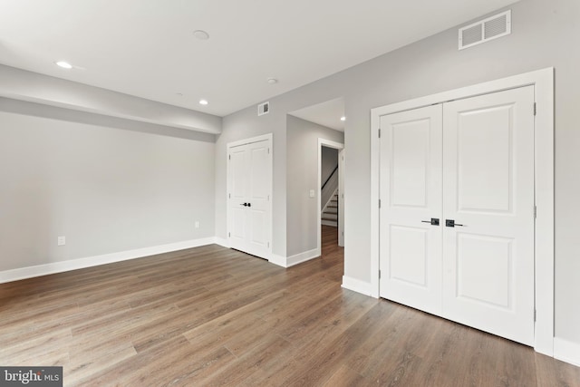 unfurnished bedroom with wood-type flooring