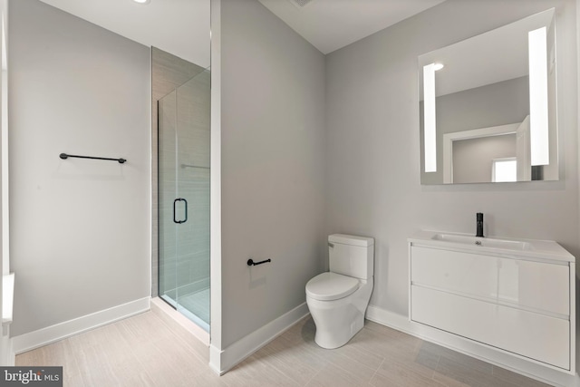 bathroom featuring a shower with shower door, vanity, and toilet