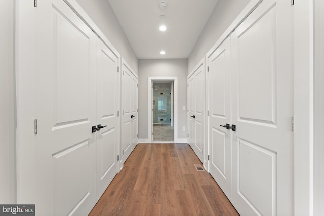 hall with hardwood / wood-style floors