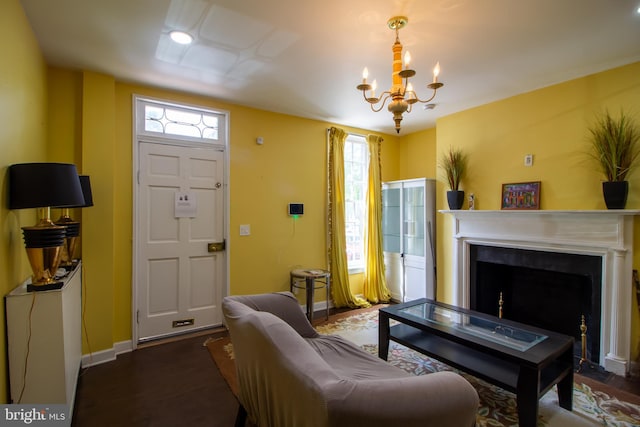 living room featuring dark hardwood / wood-style floors, a chandelier, and plenty of natural light