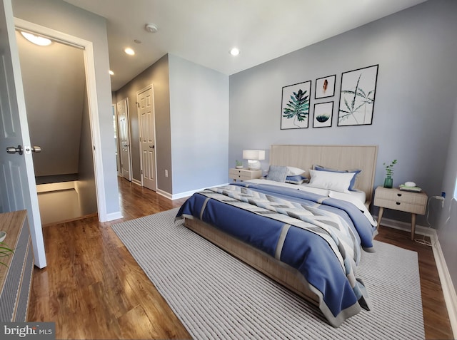 bedroom featuring a closet and dark hardwood / wood-style floors