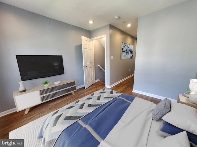 bedroom with dark hardwood / wood-style floors