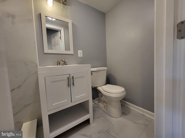 bathroom with tile flooring, vanity, and toilet