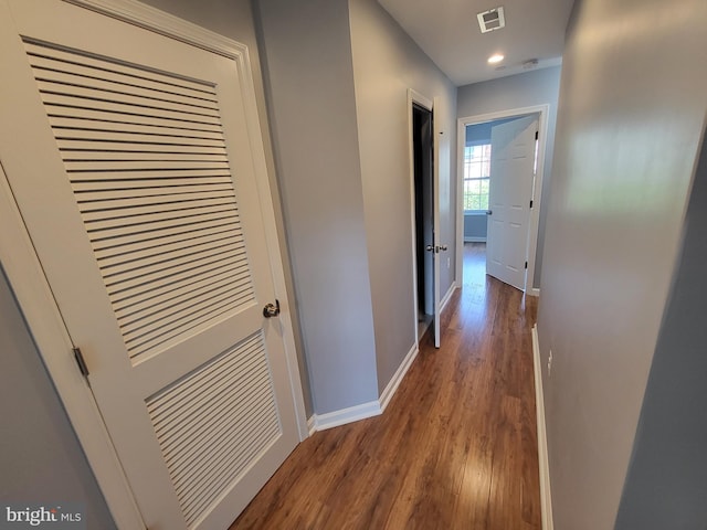 hallway with dark hardwood / wood-style floors