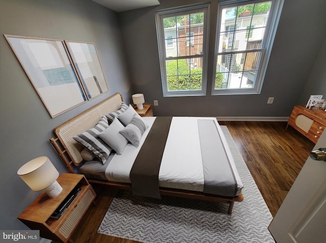 bedroom with dark hardwood / wood-style flooring