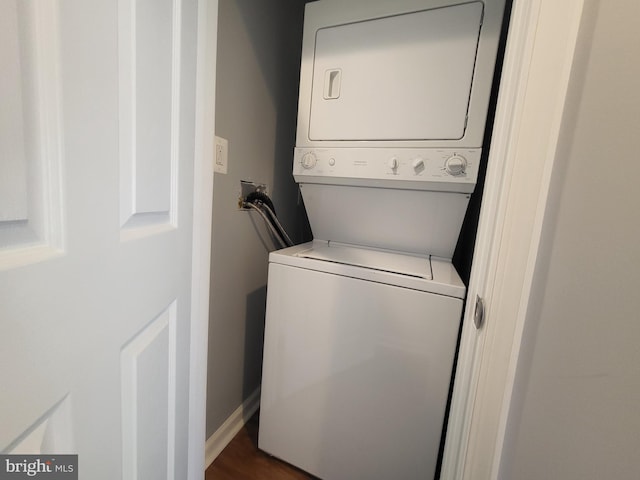 laundry room with stacked washer / dryer, washer hookup, and hardwood / wood-style flooring