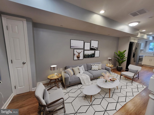 living room with light hardwood / wood-style flooring