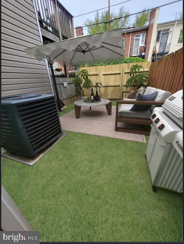 view of yard with a patio, an outdoor living space, and central AC