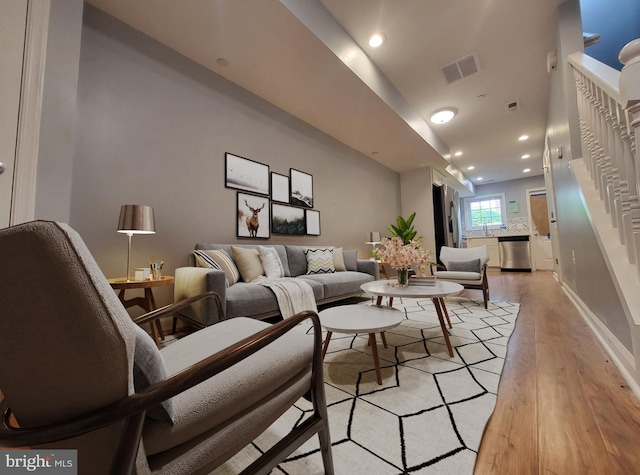 living room featuring sink and light hardwood / wood-style floors