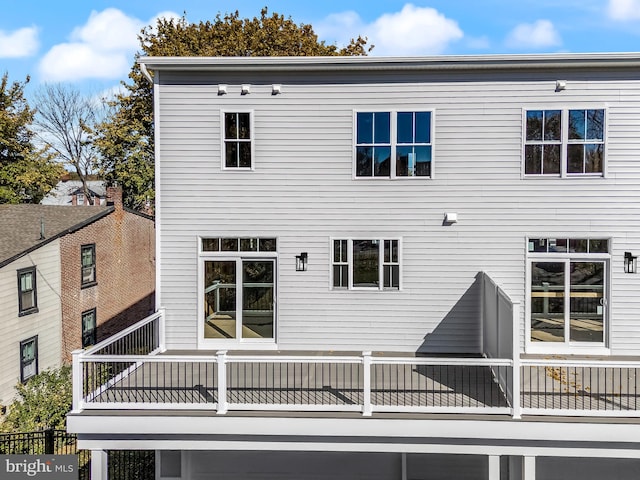 back of property featuring a balcony