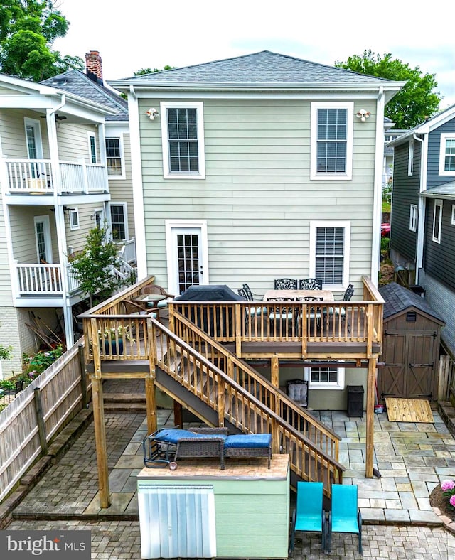 back of property with a patio area and a deck