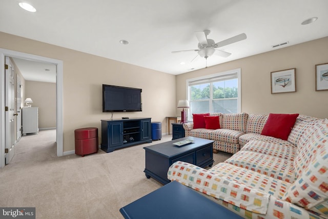 carpeted living room featuring ceiling fan