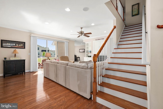 living room with crown molding, ceiling fan, and hardwood / wood-style flooring