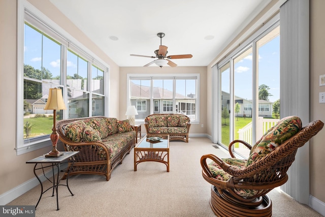 sunroom / solarium featuring ceiling fan