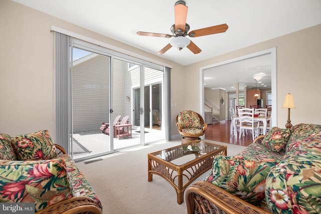 carpeted living room featuring ceiling fan