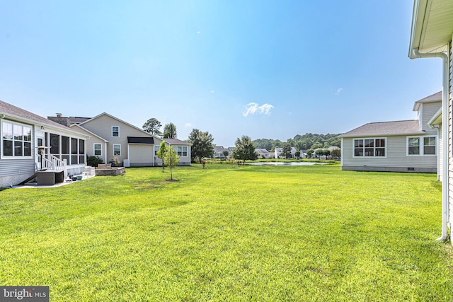 view of yard with a sunroom