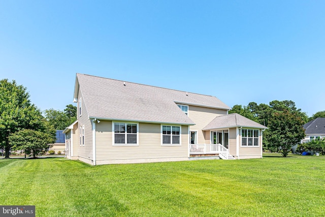 back of house with a lawn