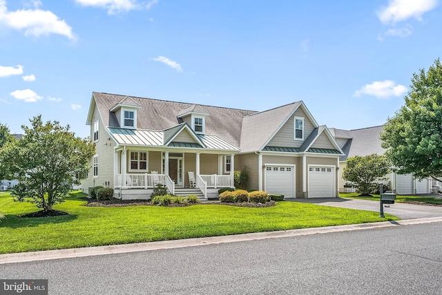 view of front of home with a garage, a front yard, and a porch