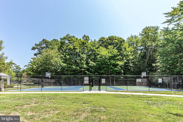 exterior space with a yard and basketball hoop