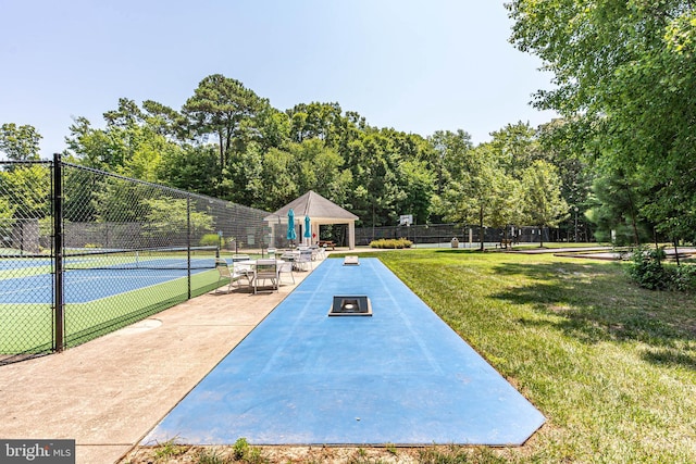 view of community with a yard, a gazebo, and tennis court