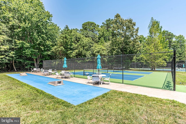 exterior space with a yard and tennis court