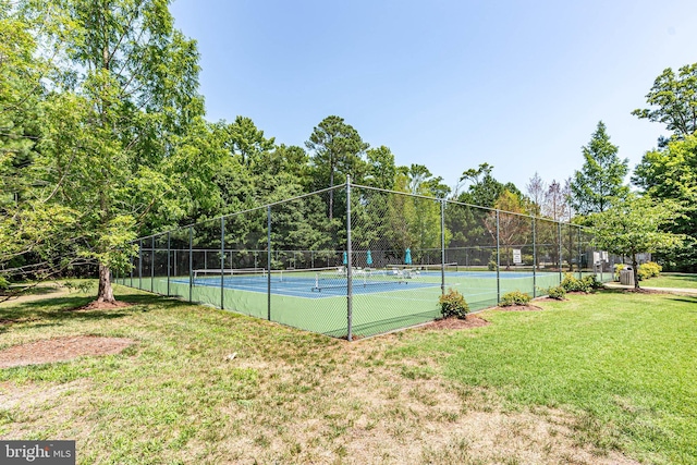 view of sport court featuring a lawn