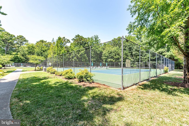 view of sport court featuring a lawn