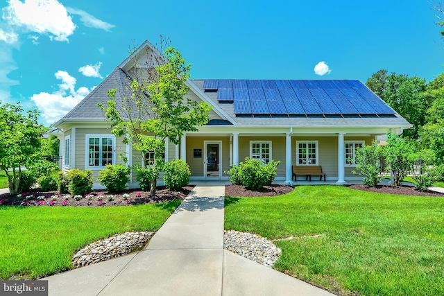 view of front facade with a porch, a front lawn, and solar panels