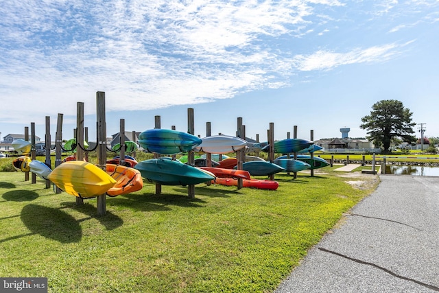 view of jungle gym featuring a water view and a yard