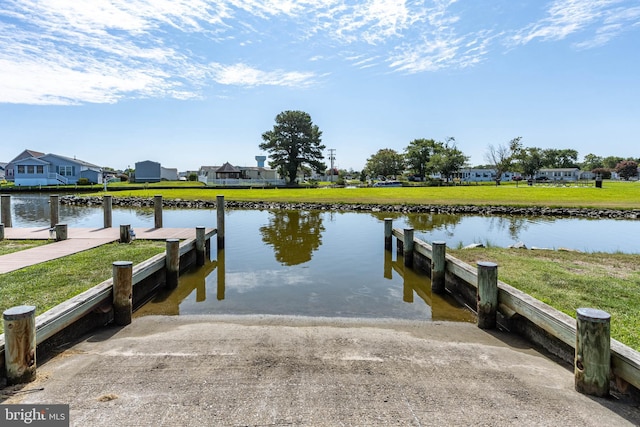 dock area featuring a water view and a yard